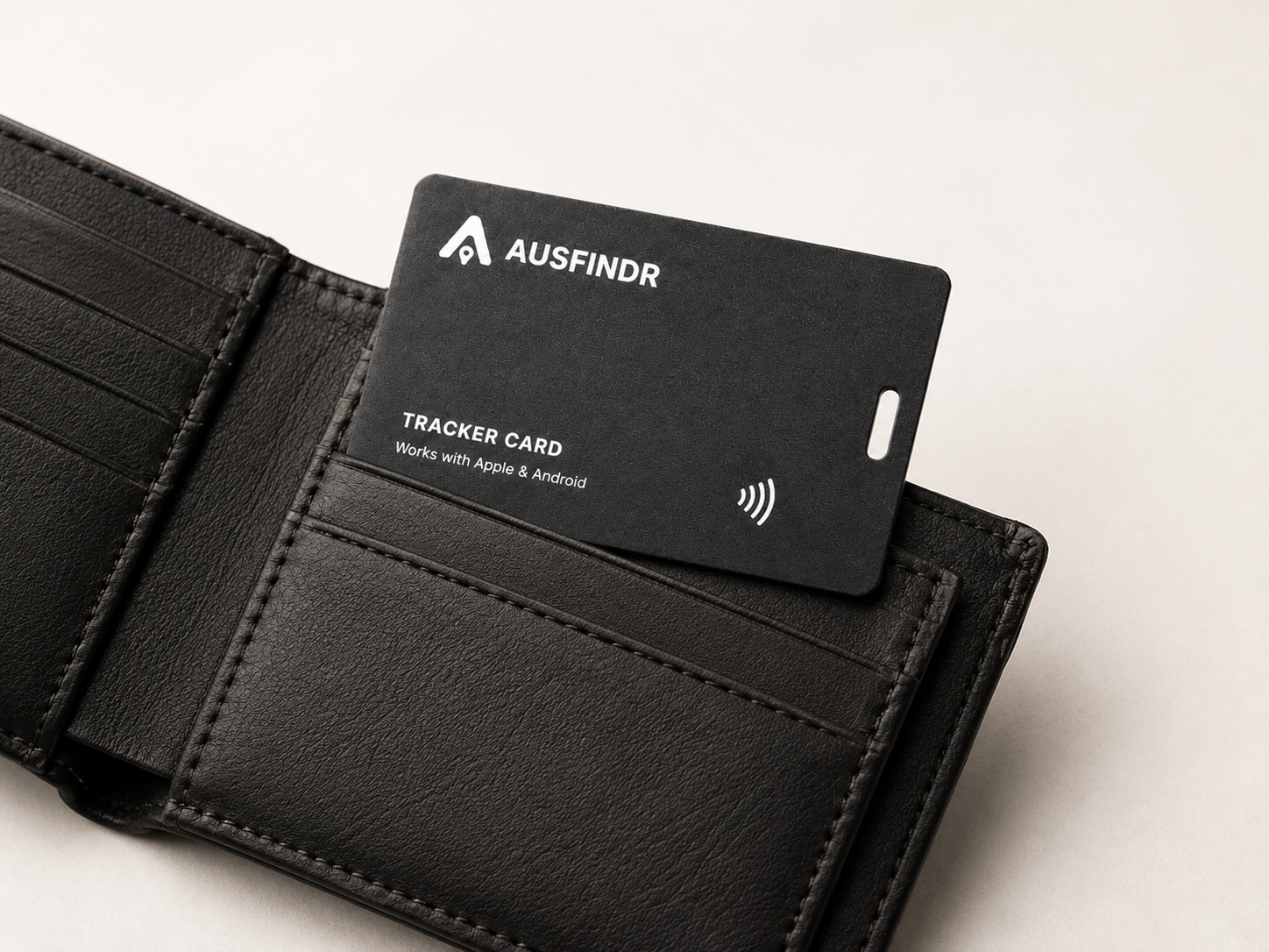 Black tracker card with 'Ausfinder' branding inside an open black wallet.